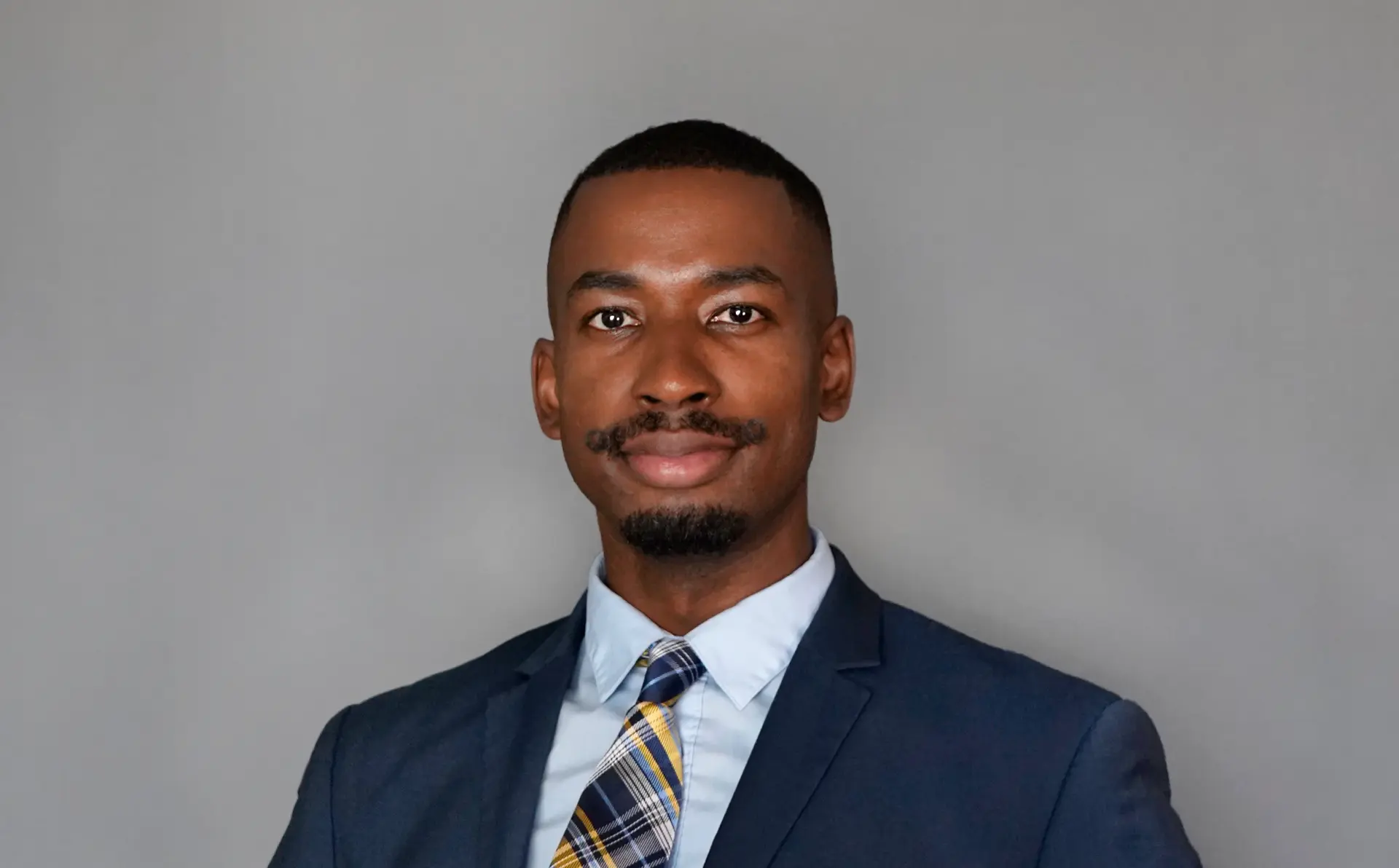 Portrait of the founder of IS Consulting in a navy suit